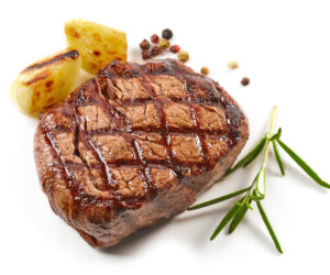 grilled beef steak with spices isolated on white background