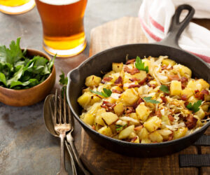 Fall side dish with fried cabbage, potatoes and bacon in a cast iron pan