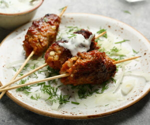 beef kebab with sauce and dill, food closeup