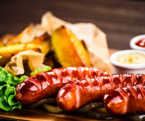 Grilled sausages, baked potatoes and vegetables