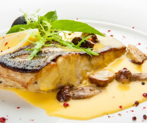 Pike perch with porcini mushrooms and potatoes. On a white plate