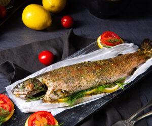 baked trout with herb filling and tomatoes
