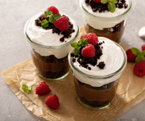 Chocolate layered dessert in a jar with brownie crumbles and pudding