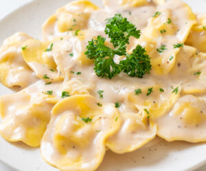 ravioli pasta with mushroom cream sauce and cheese - Italian food style