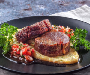 On a dish beef medallions with tomato salsa and cream polenta