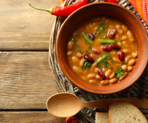 Bean soup in bowl on wooden table background