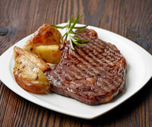 grilled beef steak on wooden table
